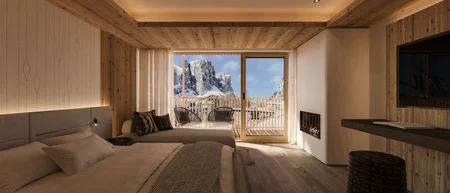Gemütliches Hotelzimmer mit Holzdecke und Bergblick vom Balkon