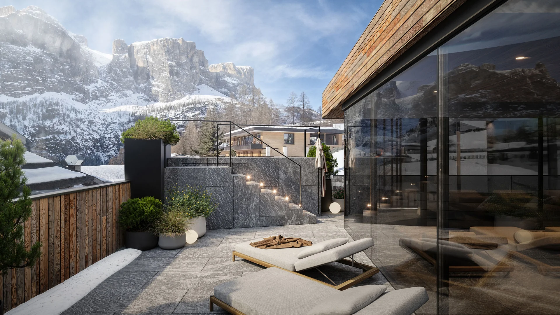 Die schönsten Eindrücke aus dem Nature Hotel Delta Terrasse mit Liegestühlen und Bergblick im Schnee bei klarem Himmel