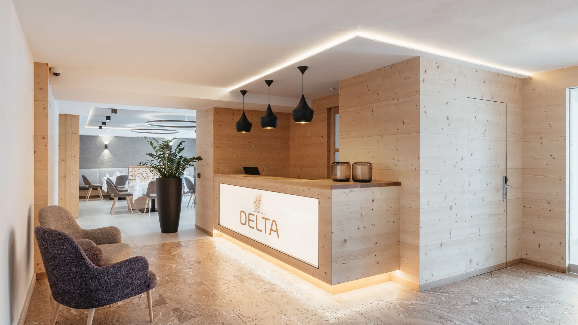 Die schönsten Eindrücke aus dem Nature Hotel Delta Moderner Empfangsbereich mit Holztheke und Sitzbereich im Hotel Delta
